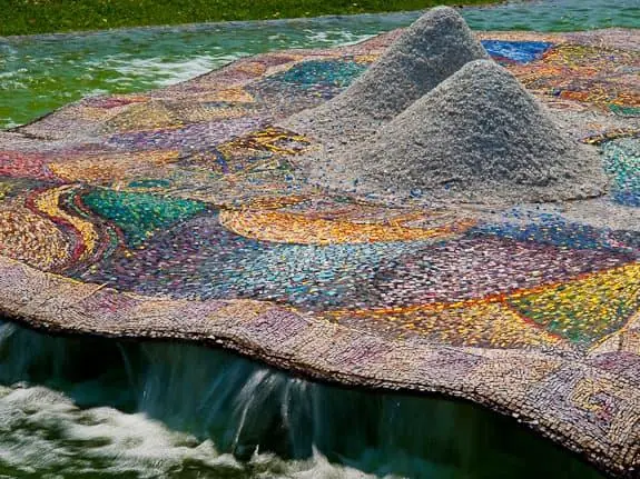 The fountain mosaic, with two mounds of marble and crystal salt above the carpet of mosaic pieces and water jets