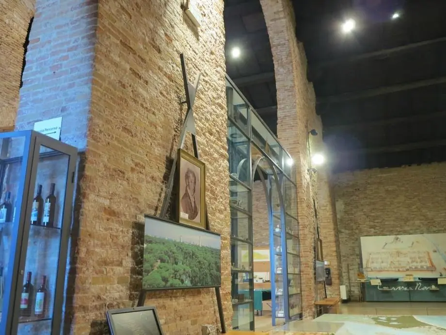 MUSA brick arches with a framed portrait, a pinewood photograph, display cases and a large map of Cervia Nuova