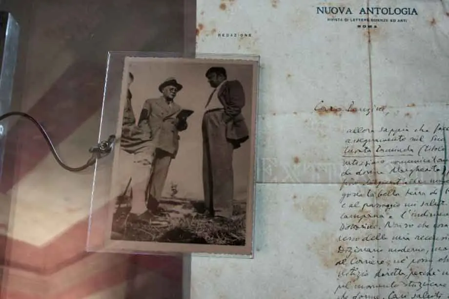An old photograph of two men and a handwritten letter on Nuova Antologia headed paper, in a display case