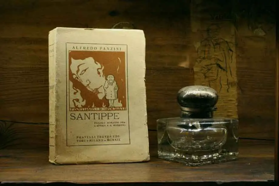 A copy of Alfredo Panzini's Santippe, in the Treves edition, beside a glass inkwell