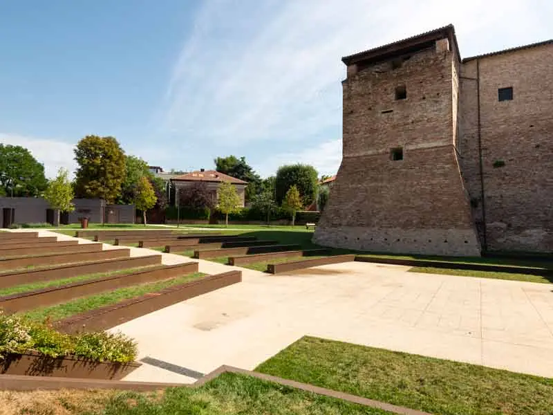 L'arena all'aperto ai piedi di Castel Sismondo, con le gradinate e il prato davanti alla torre di mattoni