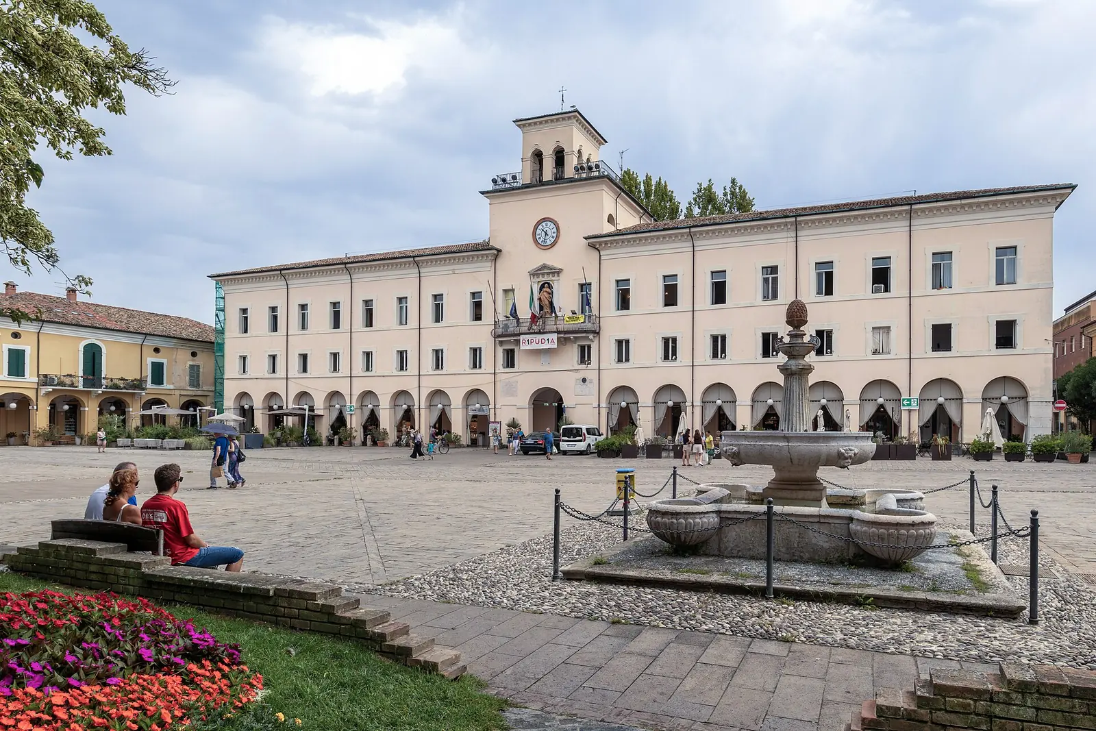 Il Palazzo Comunale di Cervia con la torretta dell'orologio, il portico e la fontana in pietra della piazza