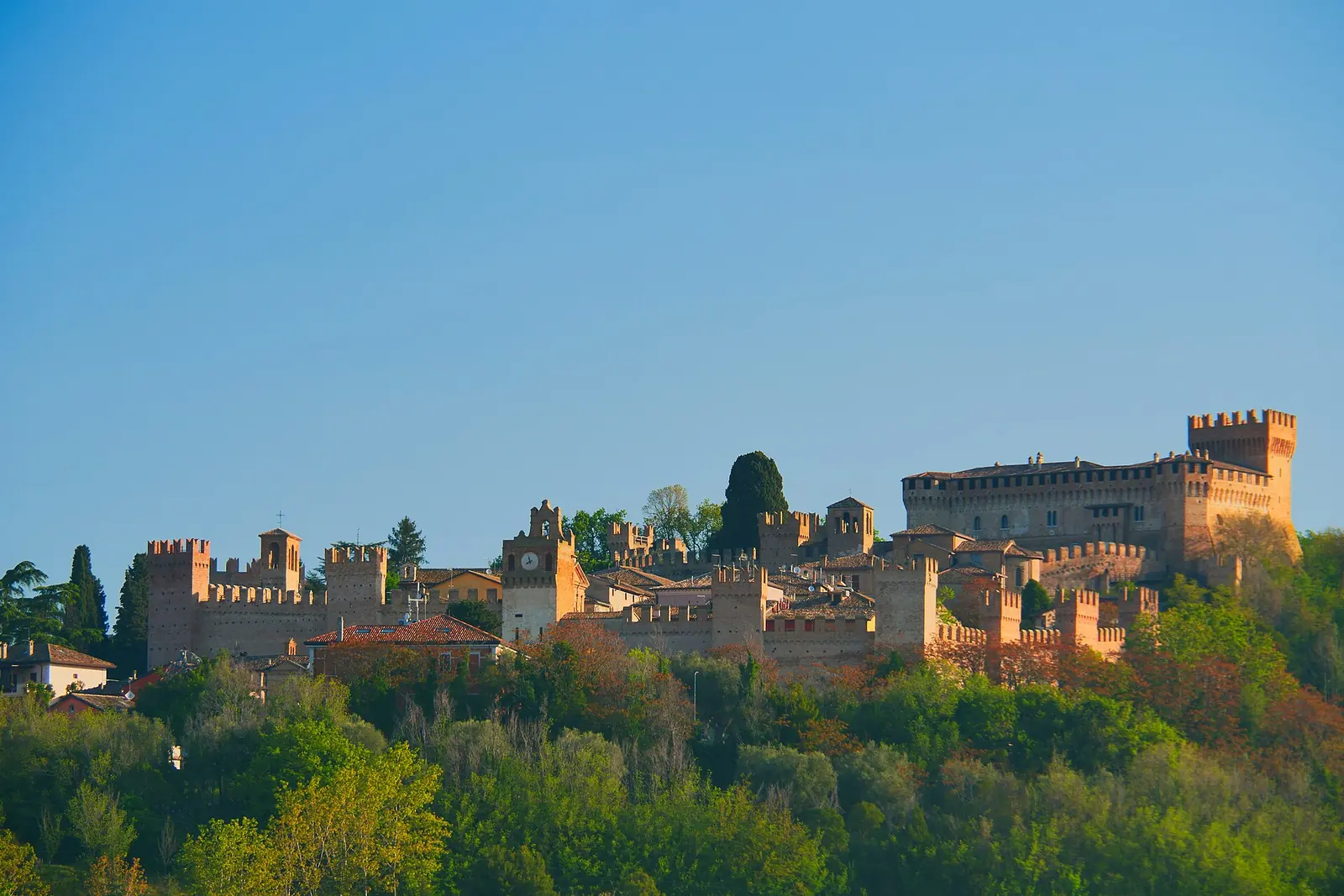 The fortified village of Gradara with its fortress and crenellated walls on the hill, in the morning light
