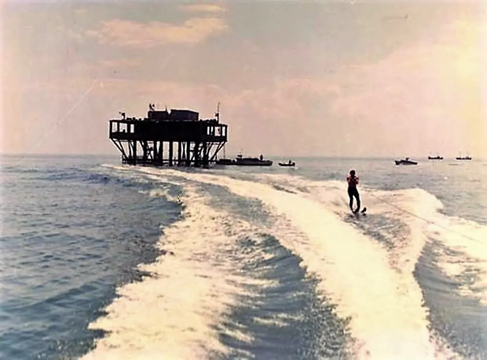 Isola delle Rose in 1968 seen from a motorboat: the platform on its supports, a water-skier in the wake and some boats