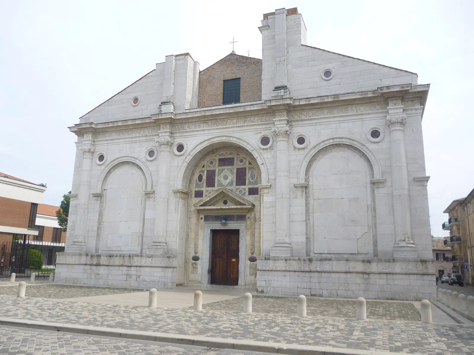 Die unvollendete Fassade des Tempio Malatestiano in Rimini mit dem Hauptportal und den beiden seitlichen Blendbögen