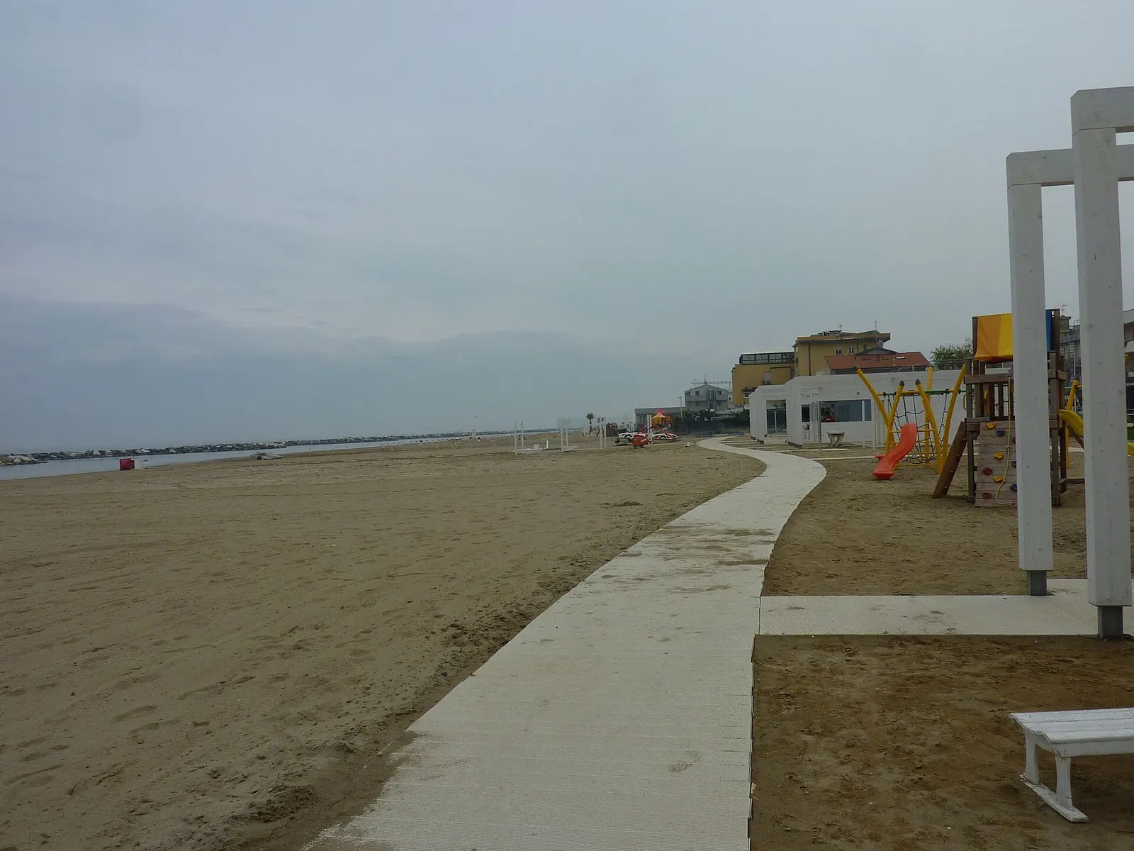La plage de Torre Pedrera, au nord de Rimini, hors saison, avec la passerelle, une aire de jeux et les hôtels du front de mer