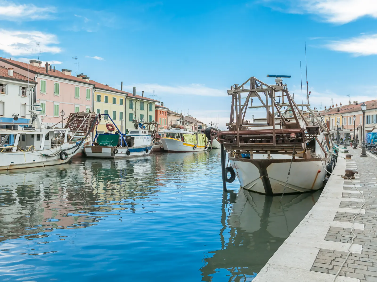 Pescherecci ormeggiati nel porto canale di Cesenatico davanti alle case colorate